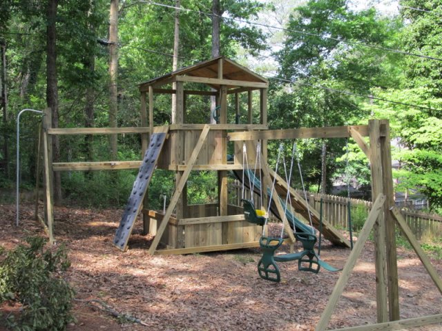 NO LONGER AVAILABLE 6x6 model as shown $3500..00  HOP's UPgrade, Shingled Roof, Wooden Ramp with Rope, Wooden Bridge, Fireman's Pole, Grey Rock Climbing Wall, Soft Grip Swings, Childseat, and Glidder Horse