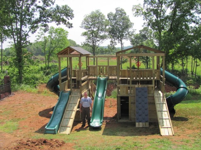 8x8 Mammoth and 4x8 Eagl's Nest models as shown $9550 including 10' Wave Slide, Enclosed Turbo Slides, 13' Wave Slide, Shingled Roofs, Tire Swing, Soft Grip Swings, Trapeze Bar with Rings, Rock Climbing Wall, Wooden Bridge with Wall Boards, and more